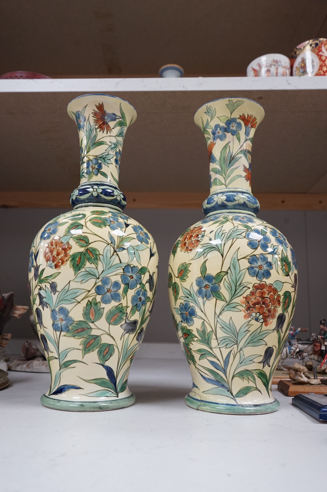 A pair of Doulton Lambeth Persian inspired faience vases, dated 1877, restored, 37cm high